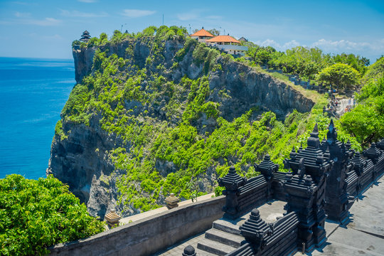 Beautiful sunny day for tourists to visit the amazing Uluwatu temple in Bali, Indonesia