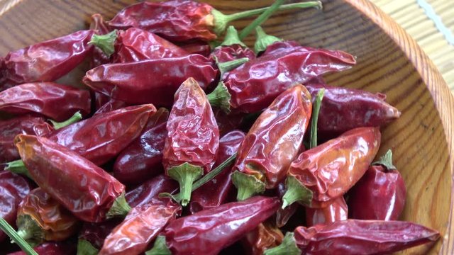 Rotating dry red hot chili peppers spice food background
