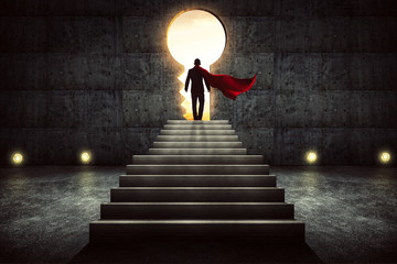 Businessman in a suit and cape stand on stair against concrete wall with exit door ,sunrise scene...