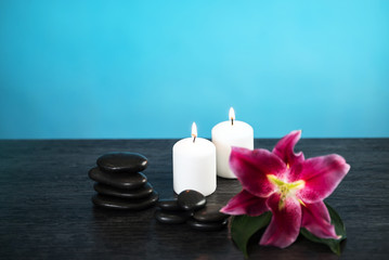 Nature products Spa and wellness setting with flowers, towels, stones and candle