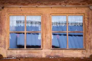 Two windows of a wooden house, Poland