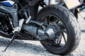 Motorcycle luxury items close-up: headlights, shock absorber, wheel, wing, toning.