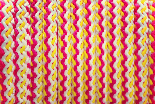Texture braided rope white, yellow, and red colors. Background.