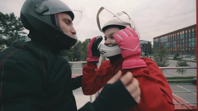 Male coach instructs a skydiver girl before flying into wind tunnel