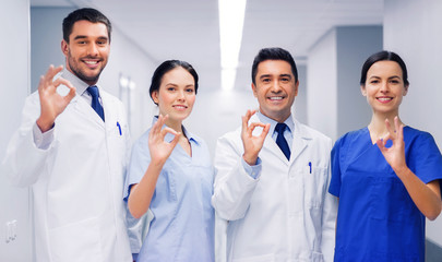 Fototapeta premium group of medics at hospital showing ok hand sign