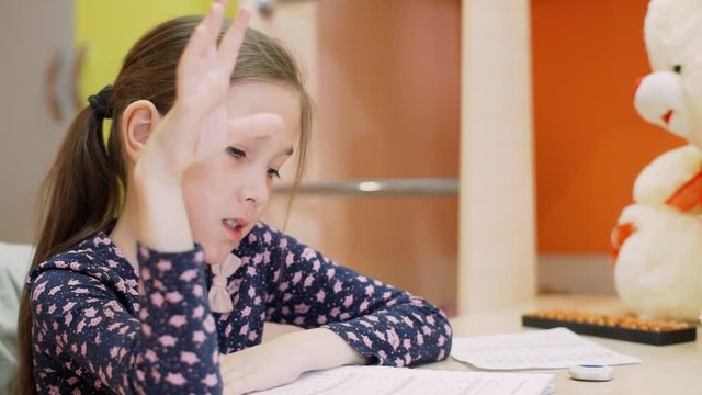 A girl of 8 years of age studies at home on mental arithmetic