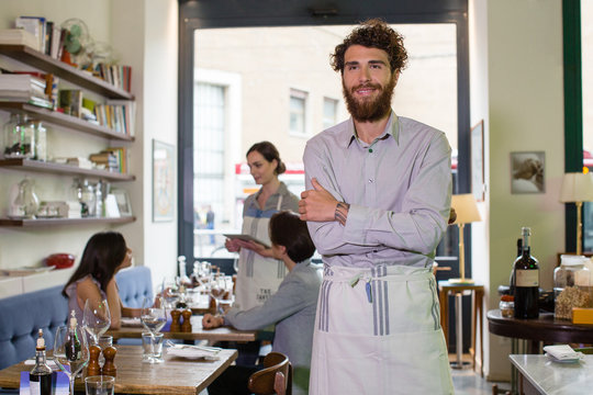 Happy small business owner in his restaurant