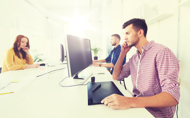 man or designer with computer and tablet at office