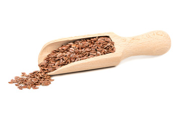 Flax seed in wooden scoop on white background