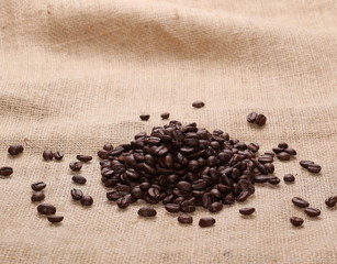 pile coffee beans on jute background, texture
