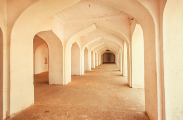 Old stone arches inside the ancient palace in India.