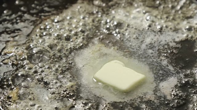 butter melting in black pan