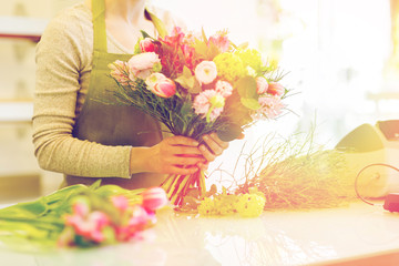 close up of woman making bunch at flower shop