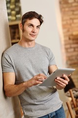 Casual man holding tablet