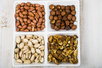 Bowl with nuts on a  wooden table