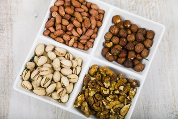 Bowl with nuts on a  wooden table