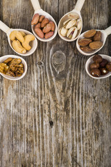 Fototapeta na wymiar Nuts in a wooden spoons on a wooden table.