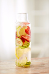Fototapeta na wymiar close up of fruit water in glass bottle