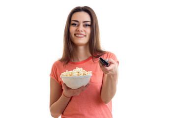 cheerful girl with pop-corn watching a tv