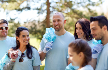 volunteers with garbage bags walking outdoors