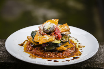 Vegetable stack - pumpkin, zucchini, red capsicum, eggplant and mushroom cooked in a tomato, onion, and garlic sauce topped with parmesan cheese