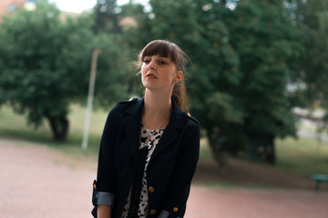 Business lady in a business suit in a city by a summer day.