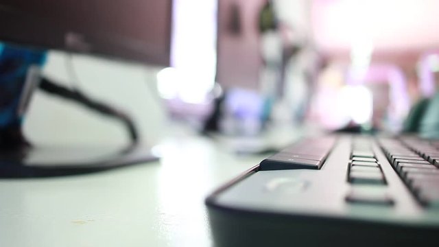 blurred of laptop keyboard computer in computer technology at library Conner background
