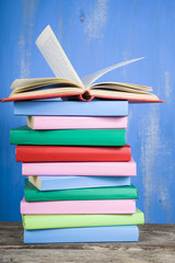 Stack of books on a blue background.