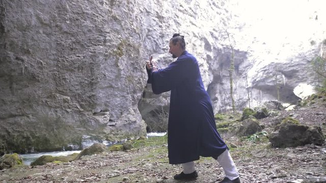 Man in Kimono practice Wudang QiGong Technique in Cave 4K