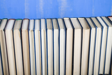 Stack of books on a blue background.