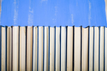 Stack of books on a blue background.