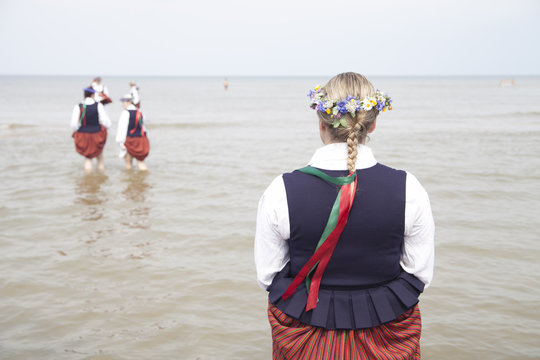 Woman in latvian costume with braid