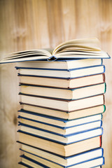 Stack of books on a wooden background.