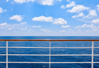 Railing of cruise ship with ocean view.