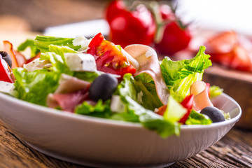 Salad. Fresh summer lettuce salad.Healthy mediterranean salad olives tomatoes parmesan cheese and prosciutto.
