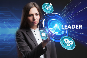 The concept of business, technology, the Internet and the network. A young entrepreneur working on a virtual screen of the future and sees the inscription: Leader