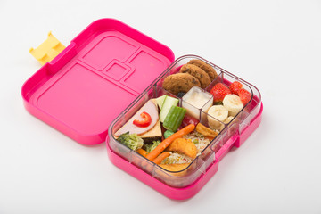 Lunch box with sandwich,apple and stationery isolated on white