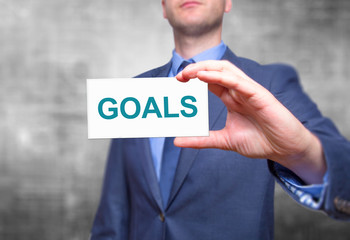 Goals text with businessman holding a sign. Business concept. Stock Photo
