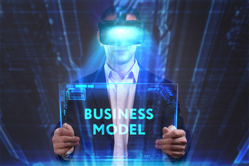 Business, Technology, Internet and network concept. Young businessman working in virtual reality glasses sees the inscription: Business model