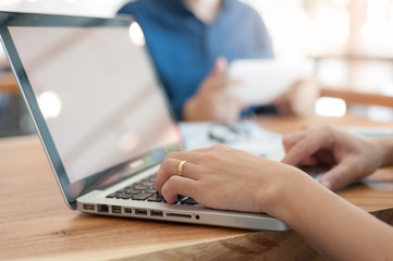 Asian man using laptop computer in cafe,