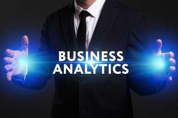 Business, Technology, Internet and network concept. Young businessman working on a virtual screen of the future and sees the inscription: Business analytics