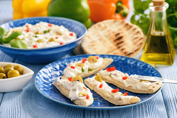 Feta cheese spread with olives and pepper served with pita bread. Greek style dish.