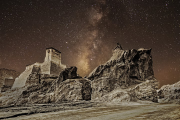 Ruins and Basgo Monastery surrounded with stones and rocks , clear sky with galaxy or milkyway in the background,  Leh, Ladakh, Jammu and Kashmir, India - tinted stock image of Indian monasteries. - obrazy, fototapety, plakaty