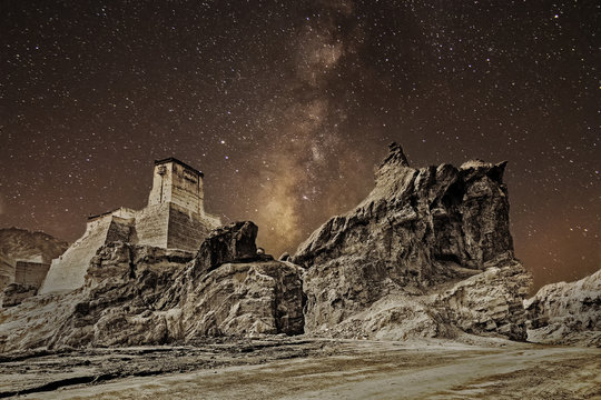 Ruins and Basgo Monastery surrounded with stones and rocks , clear sky with galaxy or milkyway in the background,  Leh, Ladakh, Jammu and Kashmir, India - tinted stock image of Indian monasteries.