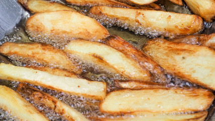 French fries is scorch cooking in stainless steel pan zoom in