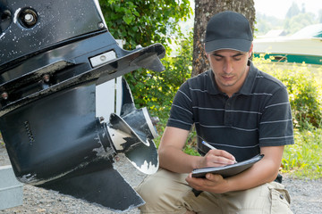 a mechanic checking the boat propeller