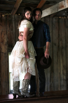 Cowboy holding woman