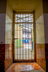 Indoor view with a door with bars, in the old prison Penal Garcia Moreno in the city of Quito