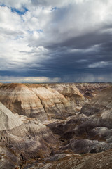 A  landscape of  a valley and colorful rock hills in the Petrified Forest National Park- Blue Mesa Trail