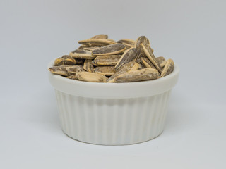  pumpkin seeds in the white cup